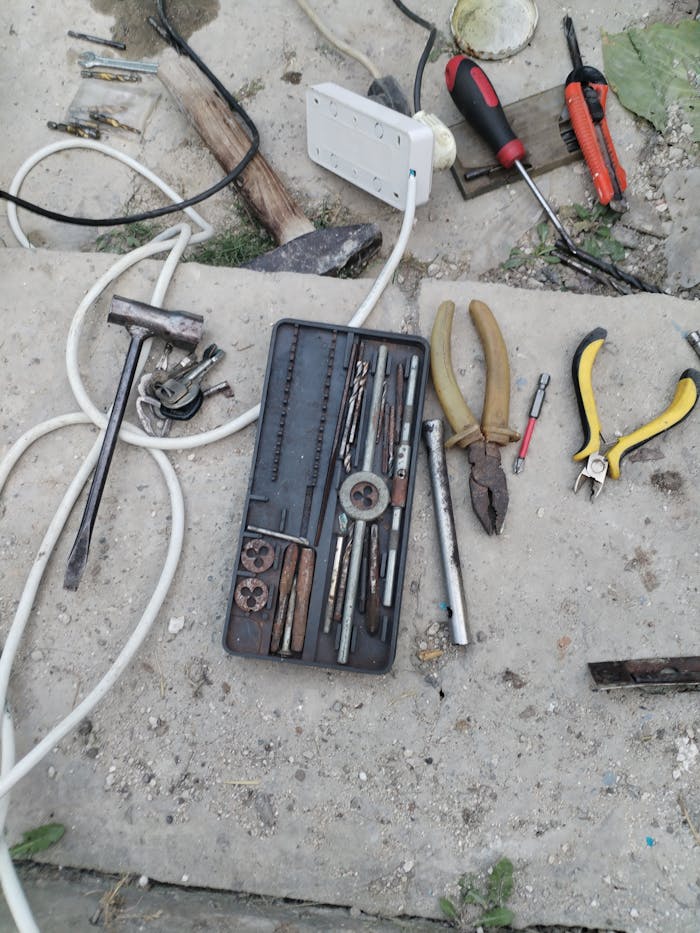 Crafting Captivating Headlines: Your awesome post title goes here A variety of hand tools laid out for repair work on a concrete floor outdoors in Moldova.